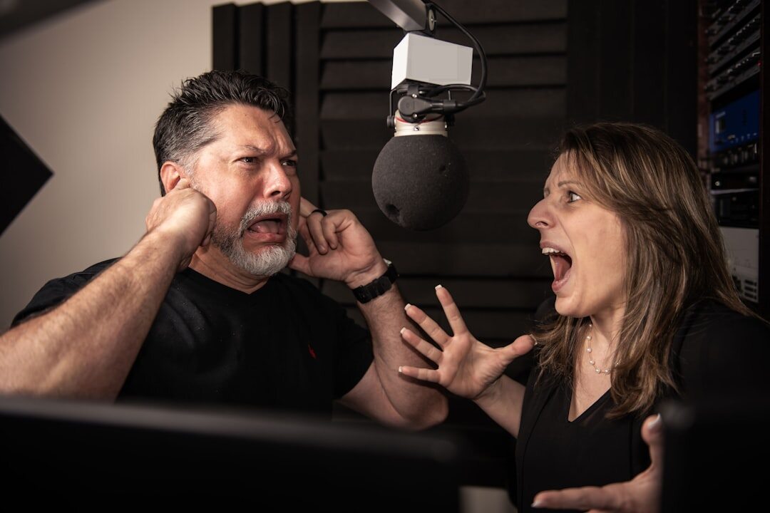 Two people having a recorded video conversation in a podcast style studio