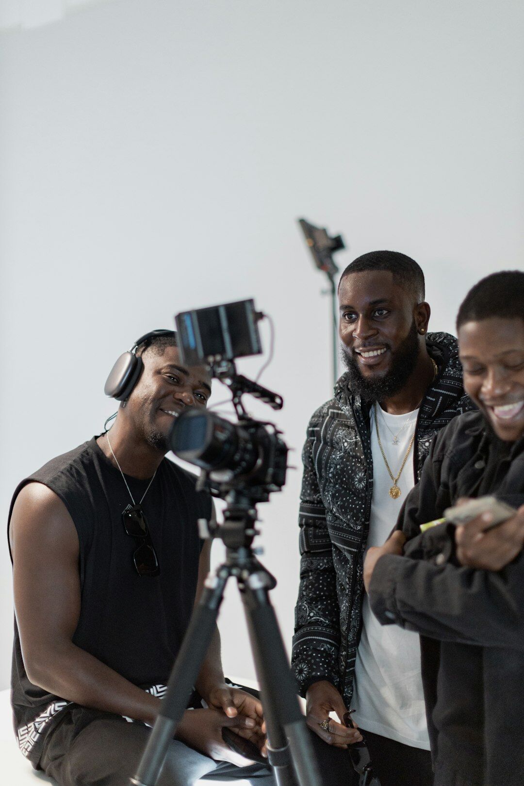 Team of media production professionals standing together in a studio